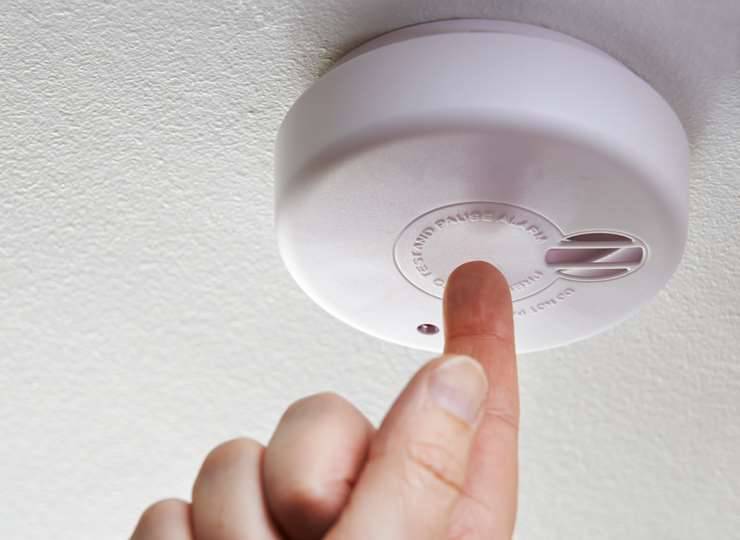 What does a blinking blue light on a smoke detector mean?